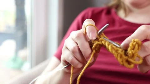 Close-up of hands knitting with yellow yarn for a calm mindful slow knitting Vídeos de archivo 346146940