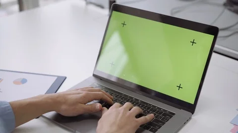 Close up hands on laptop with green screen on white table Stock Footage 103110047