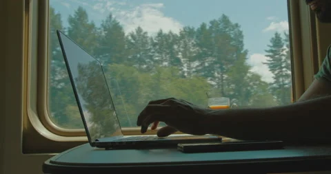 Close-up of hands on laptop keyboard by the window in a moving train. Stock Footage 161414778