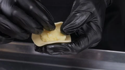 Close-up of hands in latex gloves making dumplings. Stock Footage 307771124