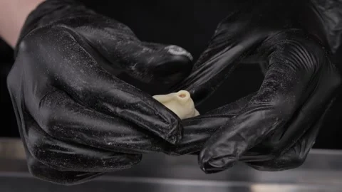Close-up of hands in latex gloves making dumplings. Stock Footage 309621992