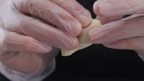 Close-up of hands in latex gloves making dumplings. Stock Footage 311698316
