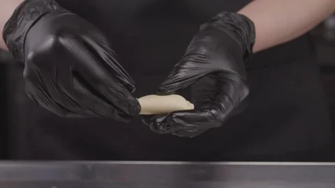Close-up of hands in latex gloves making dumplings. Stock Footage 314971425