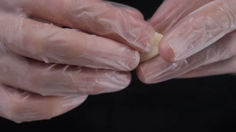 Close-up of hands in latex gloves making dumplings. Stock Footage 316192465
