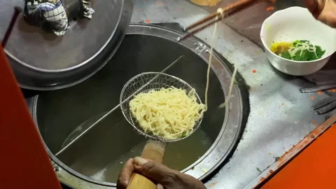 Close-up of hands lifting and draining chicken noodles using chopsticks Stock Footage 292907003