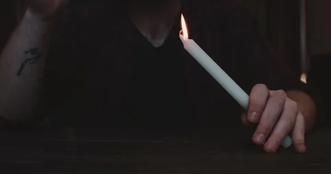 Close-up of hands lighting a candle. Dark scene with unrecognizable man Stock Footage 260936983