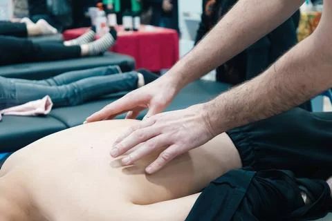 Close-up of hands mading massage process on the clients back. Concept health Stock Photos