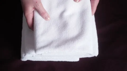 Close up hands of maid putting stack of fresh white bath towels. Stock Footage 152467096