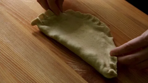 Close-up hands making chebureks. Preparing meat pies Stock Footage 172430800