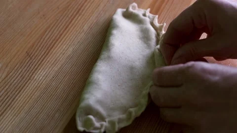 Close-up hands making chebureks. Preparing meat pies Stock Footage 189037552