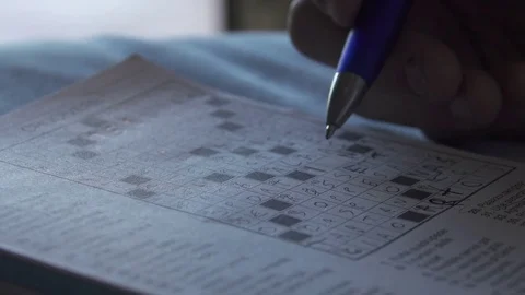 Close Up of Hands Making Crossword Puzzle Stock Footage 81212562