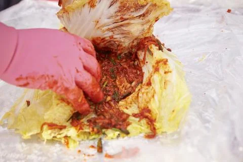 Close-up of hands making kimchi Stock Photos