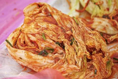 Close-up of hands making kimchi Stock Photos