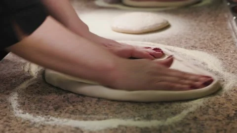 Close up of hands making pizza. Cook kneads the dough on the table and creates Stock Footage 232395430