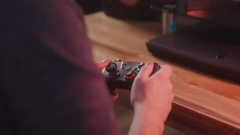 Close Up on the Hands of a Male Gamer on a Controller as He Plays a Game Stock Footage 208785603