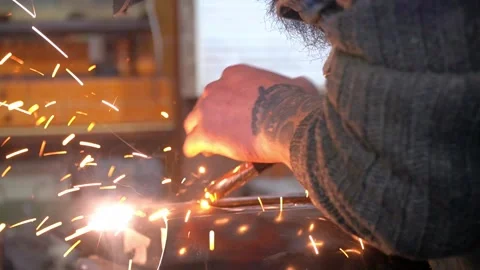 Close-up hands of male master without gloves in welding process on workshop Stock Footage 275399457