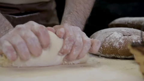 Close-up hands of man. The Baker knead dough on wooden surface Stock Footage 124307254