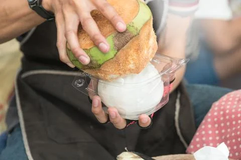 Close up The hands of man bringing coconut meat out of coconut shell for sale Stock Photos