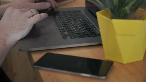 Close-up on the hands of a man browsing the Internet Stock Footage 153577313