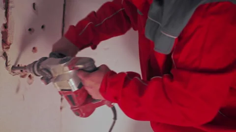 Close up hands of man builder Destroying wall in apartment with hammer drill Stock Footage 240917124