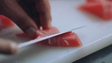 Close up hands man chef cuts raw meat with the knife in kitchen cooking Stock Footage 100303013