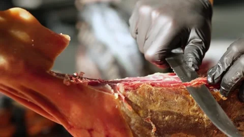 Close up of hands man Chef cutting Extra quality dry-cured spanish ham Jamon Stock Footage 279551478