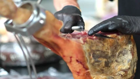 Close up of hands man Chef cutting Extra quality dry-cured spanish ham Jamon Stock Footage 282082896