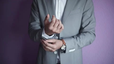 Close-up of the hands of a man in a classic gray jacket, white shirt and watch. Stock-Footage 200524570
