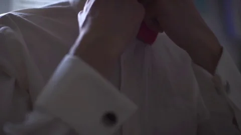 Close up of hands of man correcting red bowtie Stock Footage 70964505