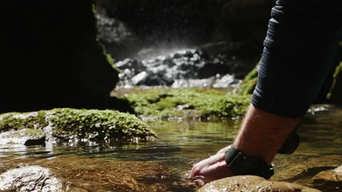 Close up of the hands of a man grabbing and lifting water in pure mountain river Stock Footage 204865844
