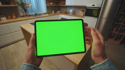 Close up hands man holding scrolling a tablet computer with a horizontal green Stock Footage 238535876