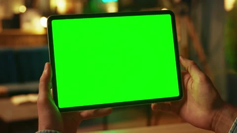 Close up hands man holding tapping on tablet computer with horizontal green Stock Footage 238745720