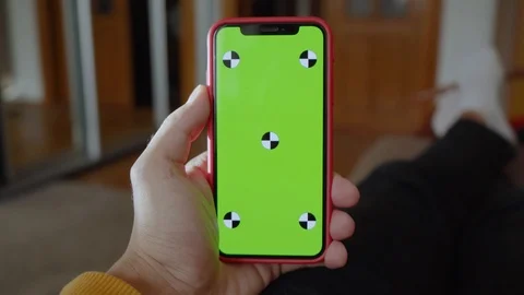 Close up hands man lying on sofa use vertical green screen phone at home living Stock Footage 118472749