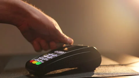 Close up hands of man making payment with credit card machine terminal while Stock Footage 194550297