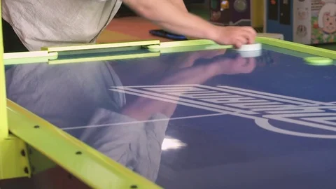 Close-up hands of man playing in an air hockey Stock Footage 80356246