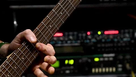 Close-up of the hands of a man playing an electric guitar in a recording st.. Stock Footage 339915387