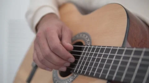 Close-up of the hands of a man playing the guitar Stock Footage 263217114