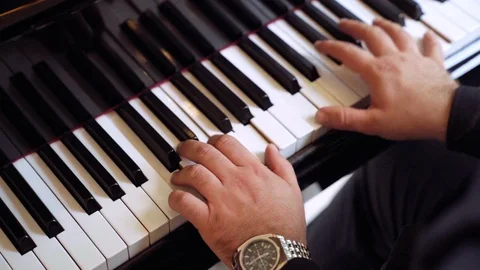 Close up hands of man playing a keyboard instrument. Male playing music on piano Stock-Footage 94762938