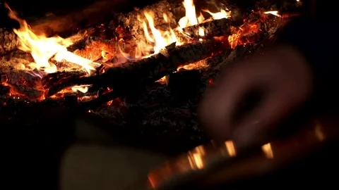 Close up hands man playing on strings guitar music in dark on background bonfire Stock Footage 81511121