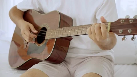 Close up hands man practicing guitar in the living room at home. Stock Footage 123418013