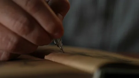 Close up hands of man sitting on bench in autumn park. She writes formulas using Video stock 201999295