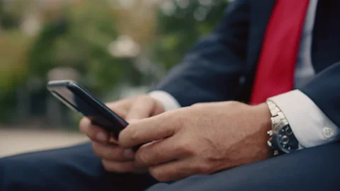 Close up Hands of a man in a suit, a man typing on the phone while sitting on a Stock Footage 218326630