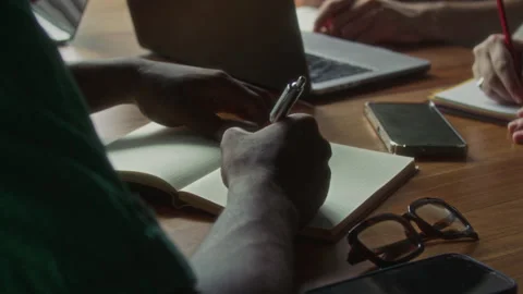 Close Up of Hands of Man Taking Notes during Business Meeting Stock Footage 340493141
