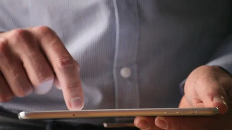 Close up of hands of man typing on digital tablet computer Stock Footage 98100036