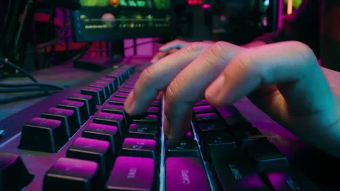 Close up hands man typing keyboard computer pc play game programmer neon Stock Footage 281609514