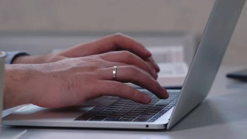 Close up of the hands of a man typing on a laptop Stock Footage 125898024
