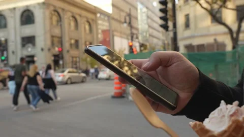 Close-up hands of man typing message on mobile phone outdoors at city street Stock Footage 231657989