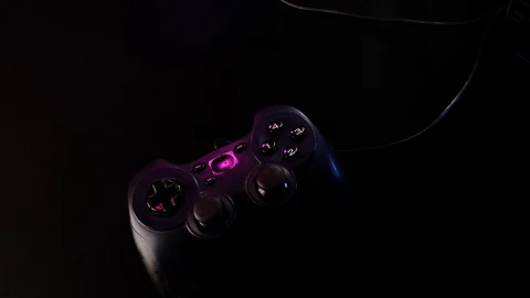 Close-up of hands. Man uses a black controller to play video games on game conso Stock Footage 130055348