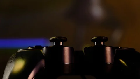 Close-up of hands. Man uses a black controller to play video games on game conso Stock Footage 130055363