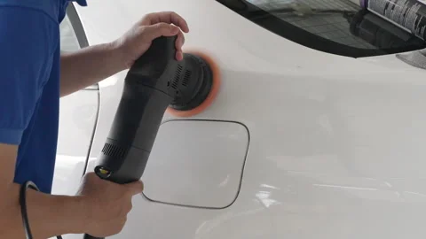 Close up hands of a man using an electric car wax polisher to wax the car Stock Footage 246115738